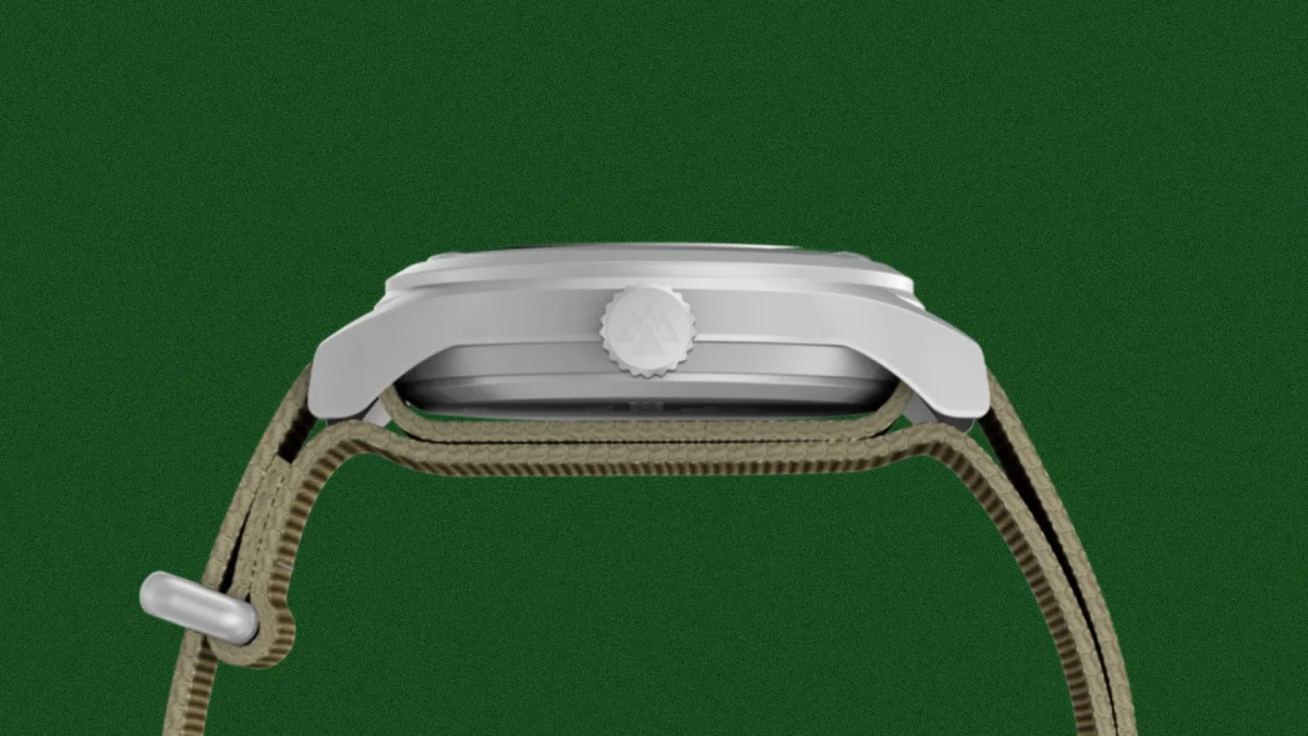 Side view of a silver watch case with a crown featuring a mountain logo and a khaki fabric strap.