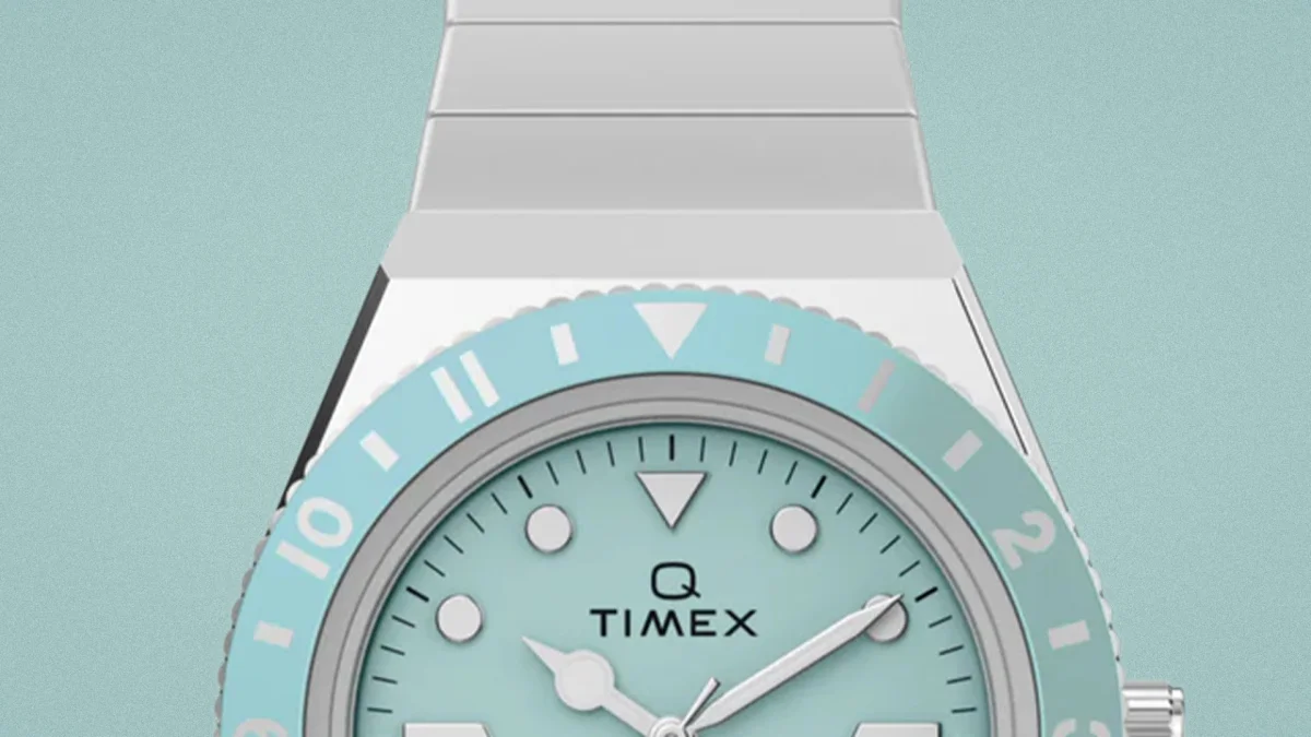 Silver Timex Q wristwatch with a light blue dial and matching bezel.
